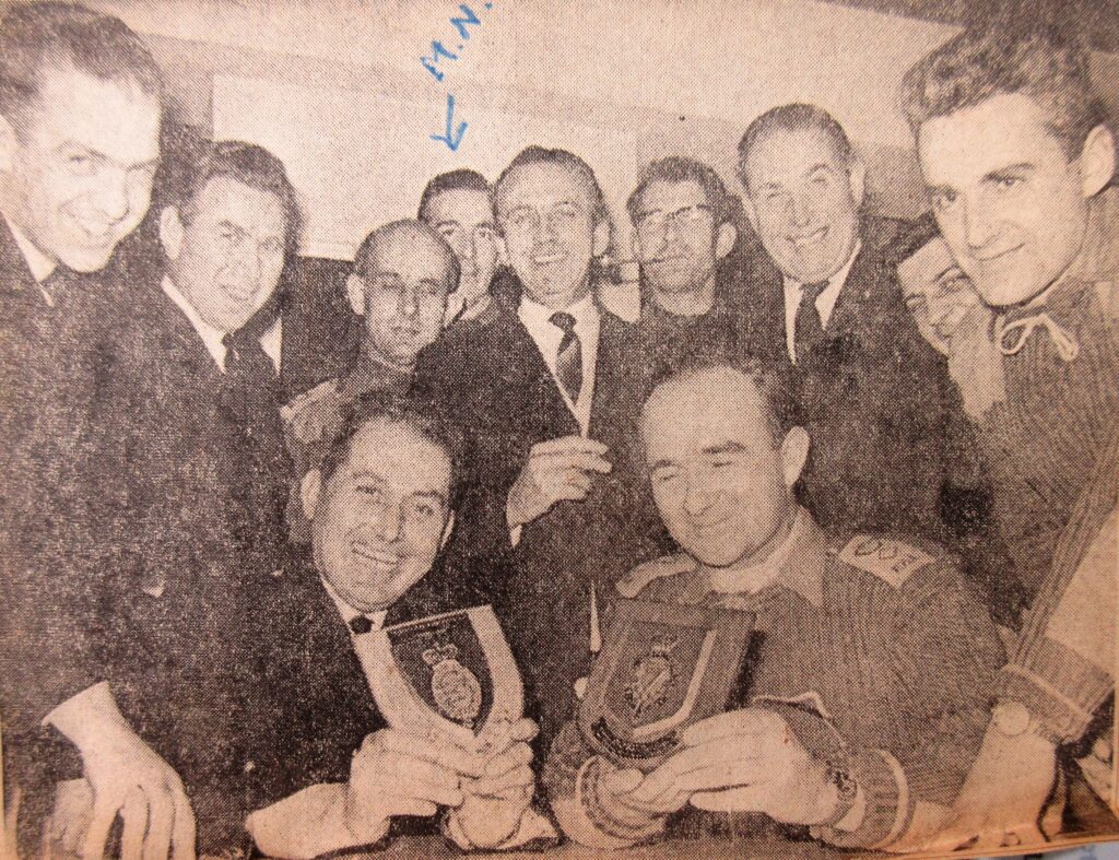 Officers celebrating with trophies in the Mess
