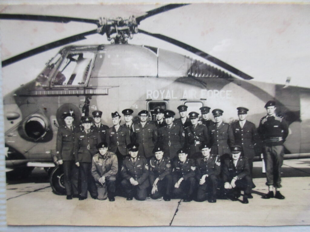 Army group photograph in front of a helicopter